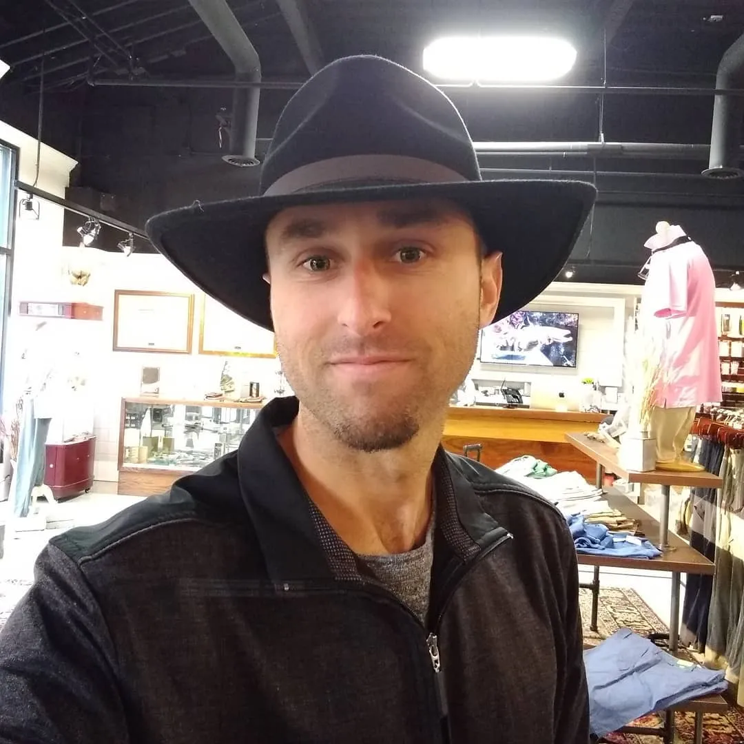 Josh in a wide-brim hat and black jacket