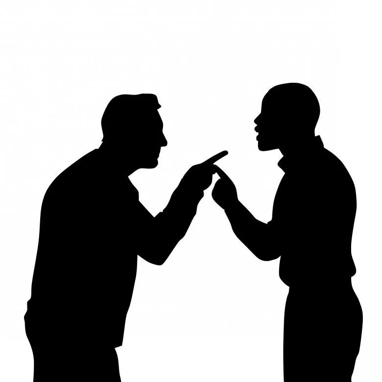 Silhouettes of two men arguing face to face