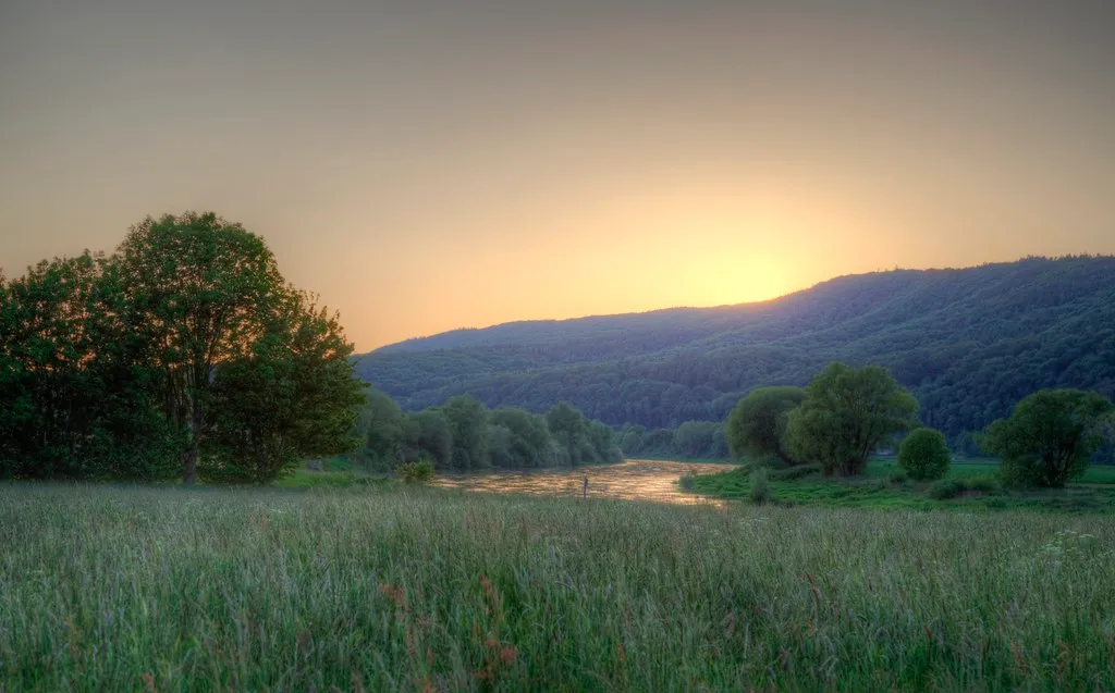 Sunrise over a green valley and mountains