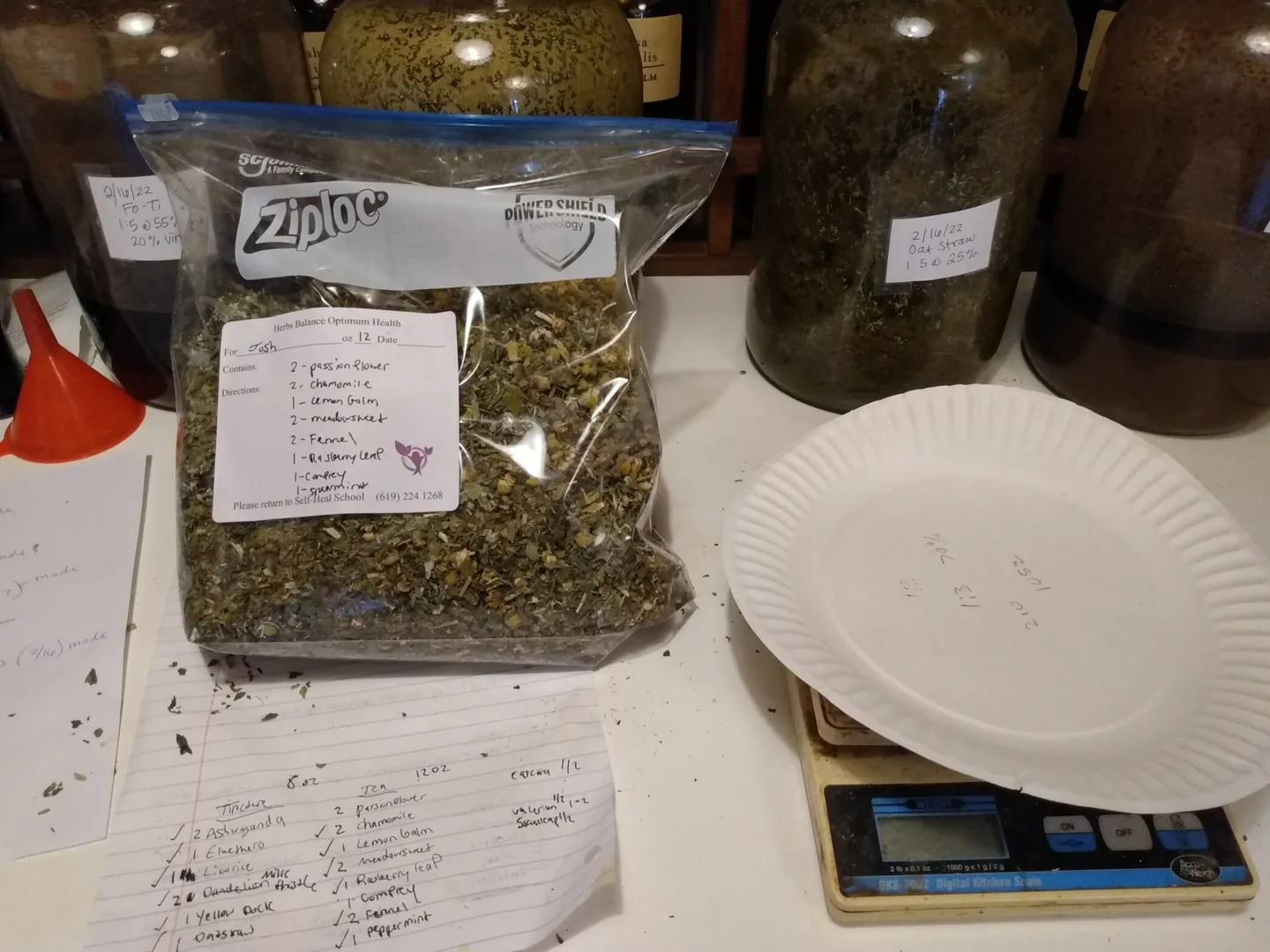 Bag of mixed dried herbs with a recipe card and a scale
