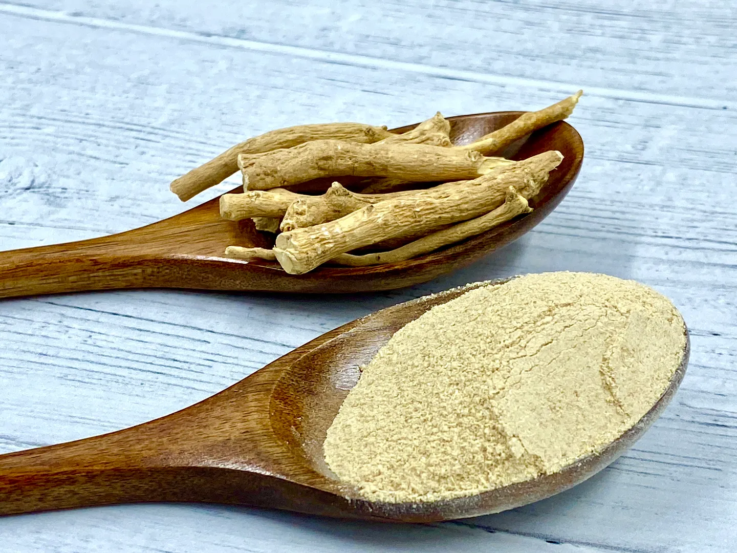 Ashwagandha root and powder on wooden spoons