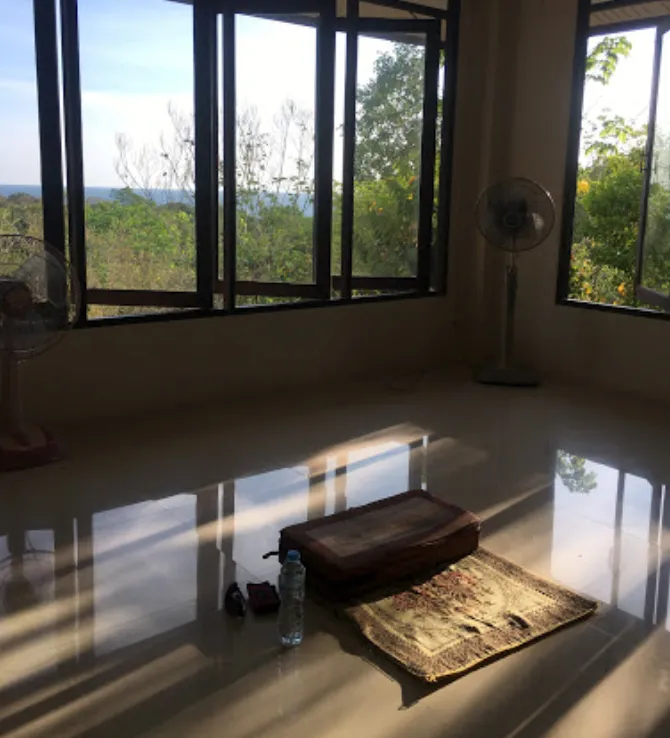 Meditation room with a cushion facing large windows