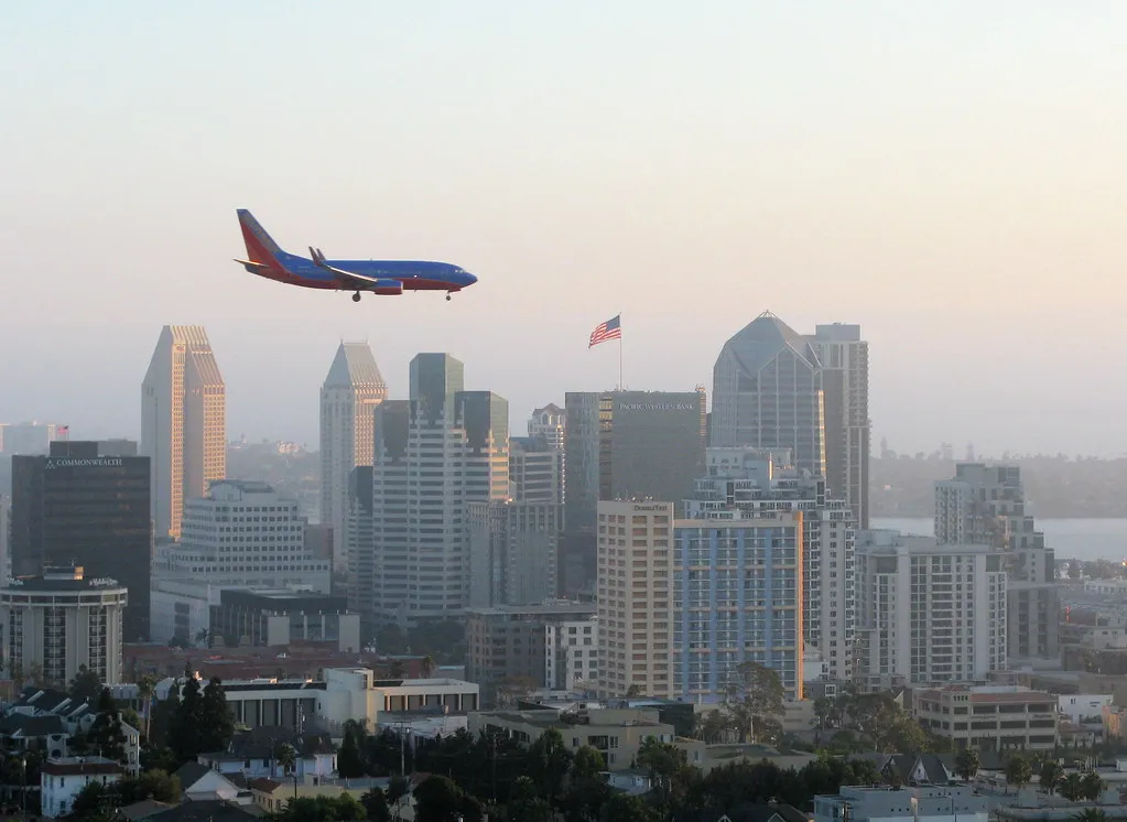 Plane flying over the San Diego skyline