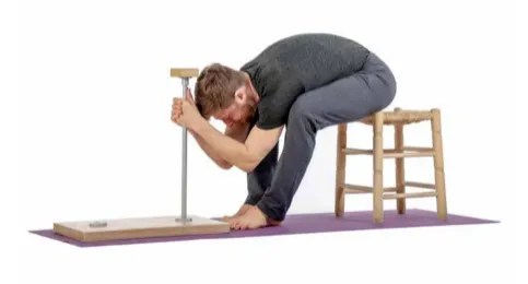 Man in a butterfly squat holding a support