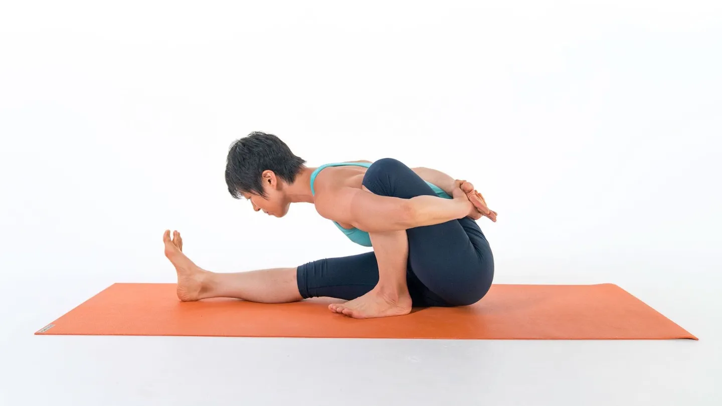 Woman in a seated marichi twist on a mat