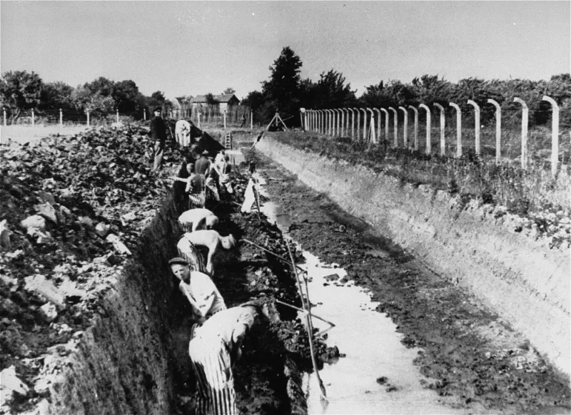 Prisoners working in a concentration camp, black and white photo