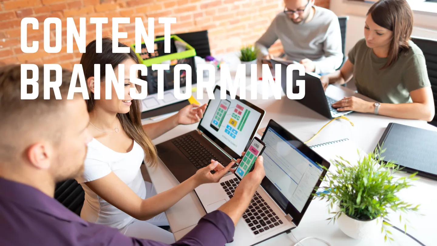 People brainstorming content around laptops