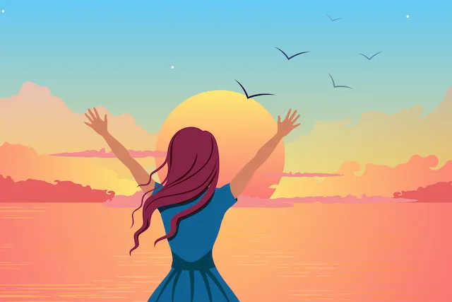 Woman with arms raised toward a sunset